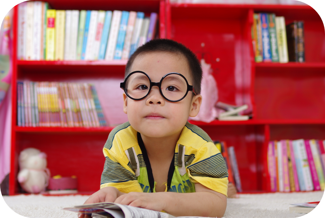 A student with glass looking up from a book he was reading